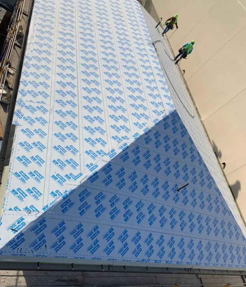 Professional roofers installing underlayment on a metal roof in Westerville